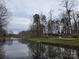 Community pond view with playground, gazebo, walking path, and mature trees for recreation at 446 Windsor Ln, Statesville, NC 28677