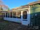 Home exterior with screened porch, showing access door to yard at 446 Windsor Ln, Statesville, NC 28677