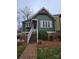Charming green home with brick walkway, covered entry, and well-maintained landscaping at 446 Windsor Ln, Statesville, NC 28677