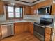 Well-equipped kitchen featuring stainless steel appliances and warm wood cabinetry at 446 Windsor Ln, Statesville, NC 28677