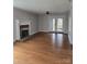 Spacious living room featuring hardwood floors, fireplace, and french doors at 446 Windsor Ln, Statesville, NC 28677