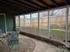 A cozy screened porch with seating, a rug, and views of the backyard at 446 Windsor Ln, Statesville, NC 28677
