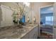 Bathroom with a granite countertop vanity, white cabinets, and a view into the bedroom at 447 Beacon Nw St, Concord, NC 28027