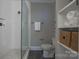 Contemporary bathroom with a glass-enclosed shower, tiled floors, and built-in shelving at 447 Beacon Nw St, Concord, NC 28027