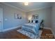 Cozy bedroom with hardwood floors, soft lighting, and neutral walls at 447 Beacon Nw St, Concord, NC 28027