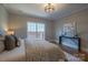 Bright bedroom featuring hardwood floors, a patterned duvet cover and neutral-toned walls at 447 Beacon Nw St, Concord, NC 28027