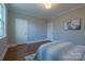Neutral bedroom features hardwood floors, decorative art, and plenty of natural light at 447 Beacon Nw St, Concord, NC 28027