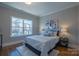 Bedroom features a plush rug, natural light, and decorative lamps at 447 Beacon Nw St, Concord, NC 28027