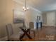 Charming dining area with a glass-top table, modern lighting, and stylish decor at 447 Beacon Nw St, Concord, NC 28027