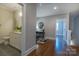 Hallway with hardwood floors leading to updated bathroom and home office at 447 Beacon Nw St, Concord, NC 28027