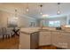 Open kitchen area with modern stainless appliances, sink, and granite breakfast bar at 447 Beacon Nw St, Concord, NC 28027