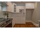 Modern kitchen featuring sleek white cabinets and countertops with subway tile backsplash at 447 Beacon Nw St, Concord, NC 28027