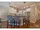 Stylish kitchen featuring a breakfast bar with pendant lighting, white cabinetry, and modern appliances at 447 Beacon Nw St, Concord, NC 28027