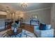 Bright living room featuring hardwood floors and an open layout with views of the kitchen and dining area at 447 Beacon Nw St, Concord, NC 28027