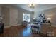 Well-lit living room featuring hardwood floors, a cozy seating arrangement, and a view of the entrance at 447 Beacon Nw St, Concord, NC 28027