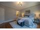 Serene main bedroom with a soft rug, neutral colors, and modern lighting fixtures at 447 Beacon Nw St, Concord, NC 28027