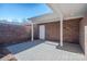 Enclosed brick patio with a paved floor, white columns, and a covered section with a doorway at 447 Beacon Nw St, Concord, NC 28027