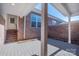 Brick patio with white support beams, a covered area, and a view of the brick wall and window at 447 Beacon Nw St, Concord, NC 28027