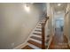 Classic wooden staircase with white risers, offering an open and inviting feel at 447 Beacon Nw St, Concord, NC 28027