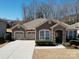 Charming home boasts a stone facade, two-car garage, and well-maintained landscaping at 5017 Willing Ct # 124, Fort Mill, SC 29707