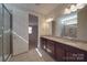 Bathroom with granite countertops, wood cabinets, a tiled shower, and a window at 5017 Willing Ct # 124, Indian Land, SC 29707