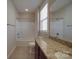 Bathroom featuring granite countertop, wood cabinets, bathtub with shower, and tiled floors at 5017 Willing Ct # 124, Indian Land, SC 29707
