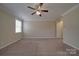 A large carpeted bedroom with neutral paint, trim, a ceiling fan, and one window at 5017 Willing Ct # 124, Indian Land, SC 29707