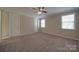 Spacious bedroom featuring neutral walls, carpet, a ceiling fan, and two windows at 5017 Willing Ct # 124, Indian Land, SC 29707