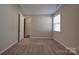 Neutral bedroom featuring carpet, window with blinds, door to closet, and overhead lighting at 5017 Willing Ct # 124, Indian Land, SC 29707