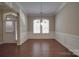 Dining room with hardwood floors, wainscoting, and a view of the entryway through large windows at 5017 Willing Ct # 124, Indian Land, SC 29707