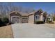 This single-story home showcases a double garage and a well-maintained front yard at 5017 Willing Ct # 124, Indian Land, SC 29707