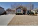 Charming single-story home featuring a stone archway, dual garage, and manicured front lawn at 5017 Willing Ct # 124, Indian Land, SC 29707