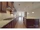 Gourmet kitchen featuring dark wood cabinets, granite countertops, stainless steel appliances, and open layout at 5017 Willing Ct # 124, Indian Land, SC 29707