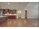 Open kitchen featuring dark cabinetry, granite counters and hardwood floors, seamlessly flowing to the living space at 5017 Willing Ct # 124, Indian Land, SC 29707