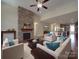 Open living room with a stone fireplace, hardwood floors, and views of the kitchen at 5017 Willing Ct # 124, Indian Land, SC 29707