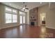 Bright living room with large windows and a stone fireplace at 5017 Willing Ct # 124, Indian Land, SC 29707