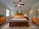 Main bedroom features a wooden bed frame, matching dressers and lots of natural light at 5017 Willing Ct # 124, Indian Land, SC 29707