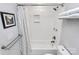 Bathroom featuring a shower-tub combo, tiled walls, and modern fixtures at 5110 Wedgewood Dr, Charlotte, NC 28210