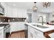 Charming kitchen with stainless steel appliances, white cabinets, and a tile backsplash at 5110 Wedgewood Dr, Charlotte, NC 28210