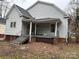 A covered back porch with steps leads to a large backyard at 517 Western Ave, Statesville, NC 28677