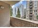 Apartment balcony view featuring a brick railing with skyline views of neighboring buildings at 718 W Trade St # 307, Charlotte, NC 28202