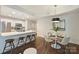 Open-concept kitchen and dining area featuring white cabinets, stainless steel appliances, and a breakfast bar at 718 W Trade St # 307, Charlotte, NC 28202