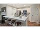 Bright kitchen featuring white cabinets, stainless steel appliances, quartz countertops and seating at breakfast bar at 718 W Trade St # 307, Charlotte, NC 28202