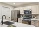 Bright kitchen featuring white cabinets, stainless steel appliances, and modern countertops and backsplash at 718 W Trade St # 307, Charlotte, NC 28202