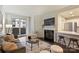 Bright living room with a fireplace, balcony, and an open view to the kitchen at 718 W Trade St # 307, Charlotte, NC 28202