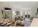 Stylish living room and dining area with modern furniture, neutral decor, and a sliding glass door at 718 W Trade St # 307, Charlotte, NC 28202
