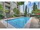 Outdoor community swimming pool with lounge chairs and lush greenery at 718 W Trade St # 307, Charlotte, NC 28202