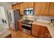 Well-equipped kitchen with stainless steel appliances, gas range, and ample counter space, adjacent to the laundry room at 8107 Crater Lake Dr, Indian Land, SC 29707