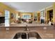 Bright living room with large windows, comfortable seating, and a fireplace, perfect for relaxation at 8107 Crater Lake Dr, Indian Land, SC 29707