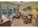 An inviting living room featuring multiple leather chairs, carpet and natural light from exterior windows at 8107 Crater Lake Dr, Indian Land, SC 29707